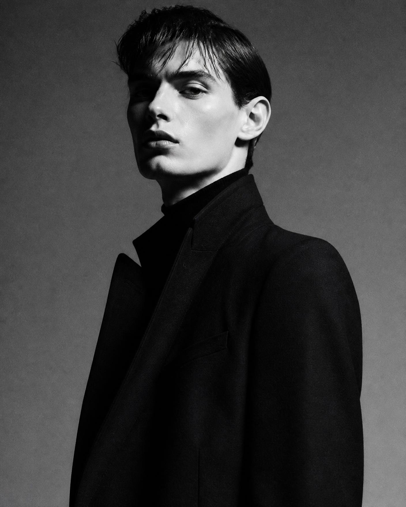 Editorial black and white portrait in a tailored coat